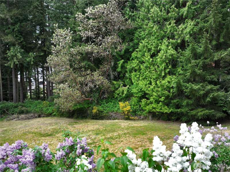 This gently sloping lot is well landscaped and partially treed.