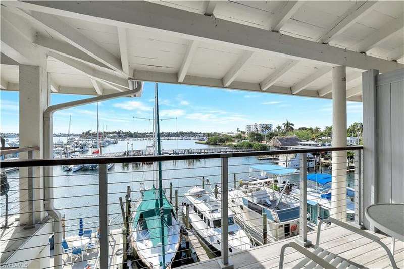 Balcony featuring a water view and view of marina