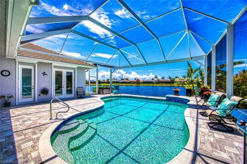 View of swimming pool with a lanai and a patio area