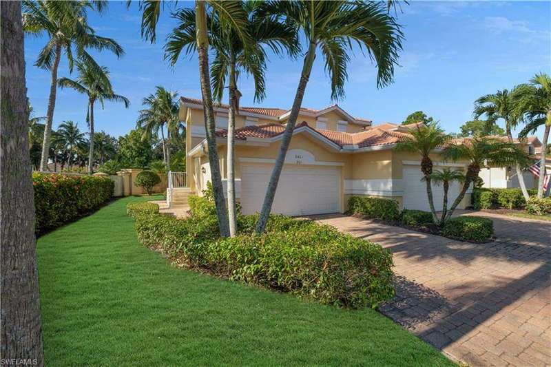 Mediterranean / spanish house with a front yard and a garage