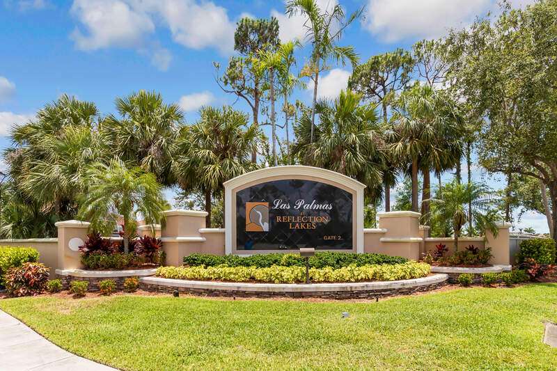 View of home's exterior featuring stucco siding, decorative driveway, a garage, and a lawn