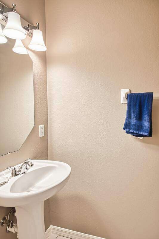 View of property featuring a tile roof, stucco siding, and decorative driveway