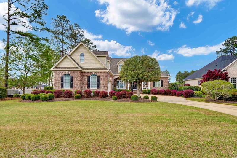 Craftsman inspired home with brick siding, a front