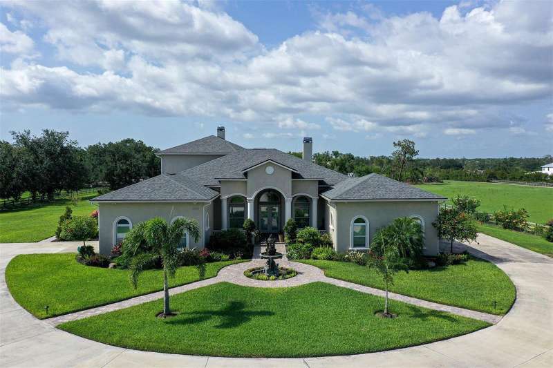 Beautiful pavers lead to the entry from garages on both sides of the home