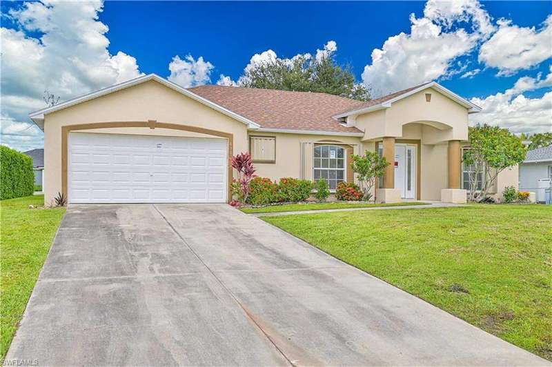 View of front of house featuring stucco siding, a front lawn, concrete driveway, a garage, and roof with shingles