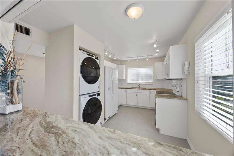 View of Par One Condo building 2 featuring uncovered parking