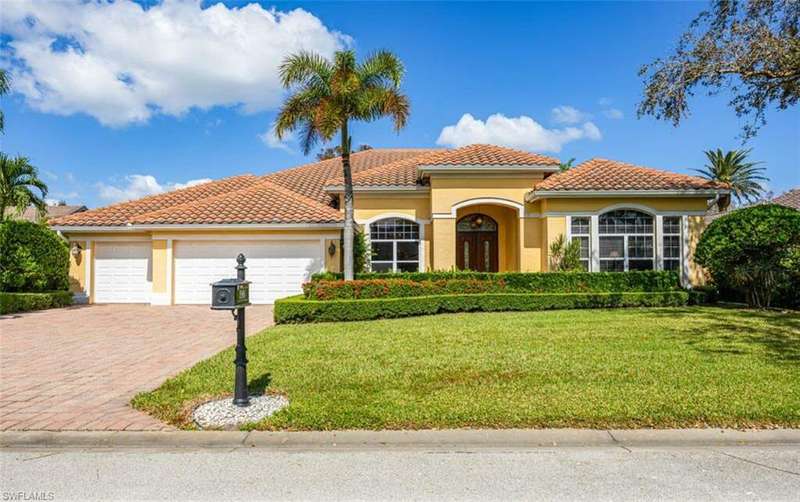 Mediterranean / spanish-style house with a garage and a front lawn