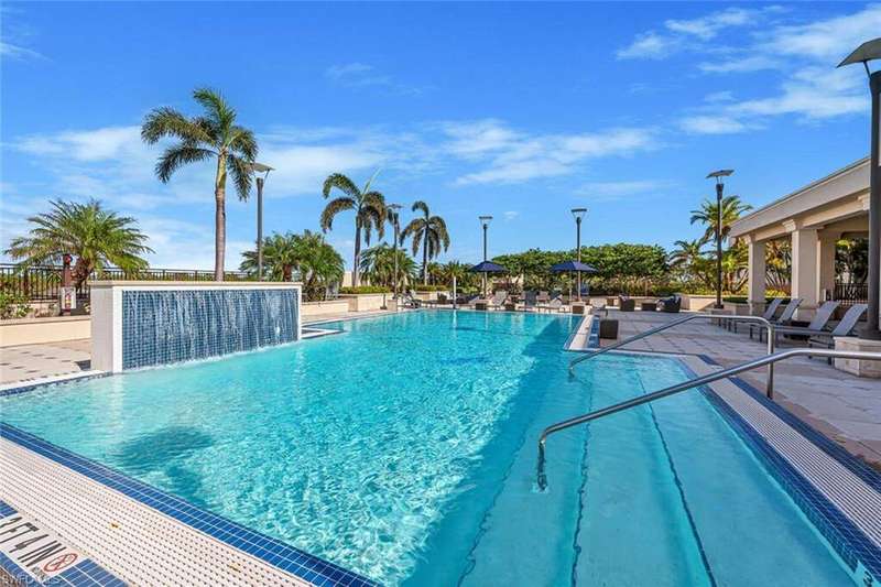Dining space with beamed ceiling, dark hardwood / wood-style flooring, ornamental molding, and a chandelier