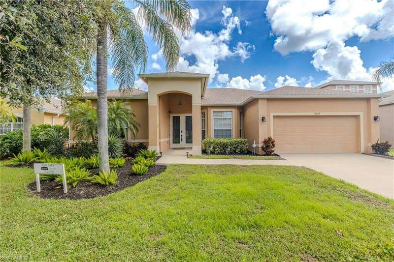 View of front of house with a front yard, french doors, and a garage