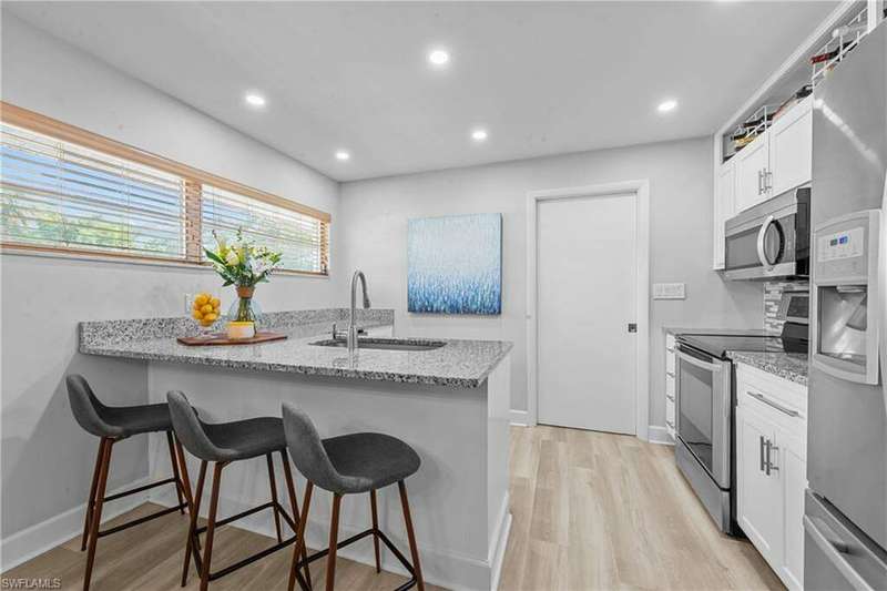 Entry view, updated light wood-style vinyl flooring