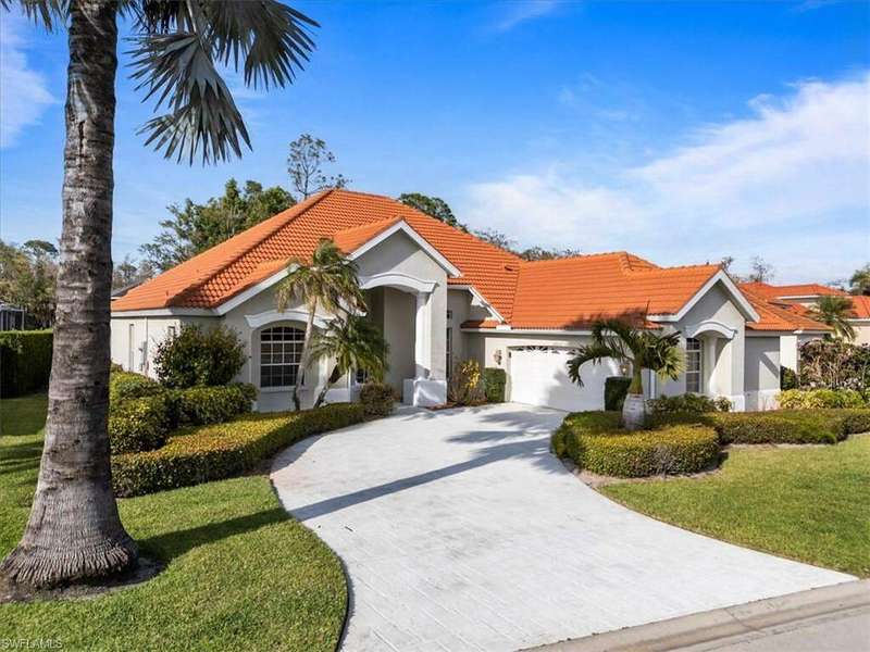 Mediterranean / spanish home featuring driveway, stucco siding, a tile roof, an attached garage, and a front yard