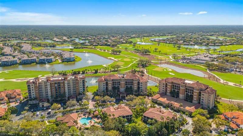 Aerial view of residential area with a golf club and a nearby body of water