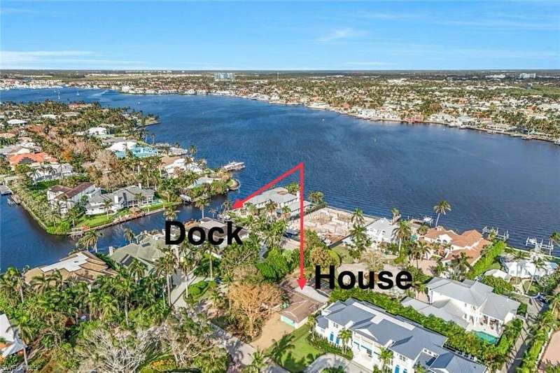 Aerial view of the corner property showing proximity to beach and canals. Deeded Boat dock is included in price.