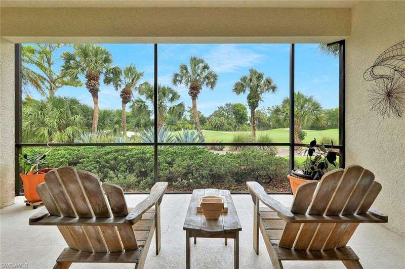 Sunroom featuring a textured wall and view of golf course