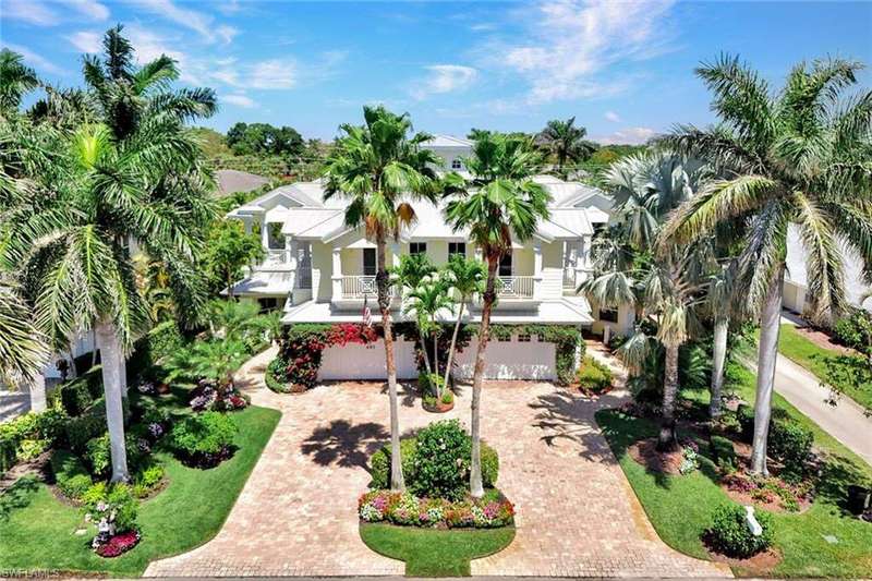 Aerial view front of home with lush landscaping