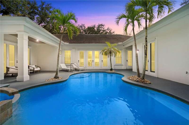 View of pool with french doors, a patio area, and
