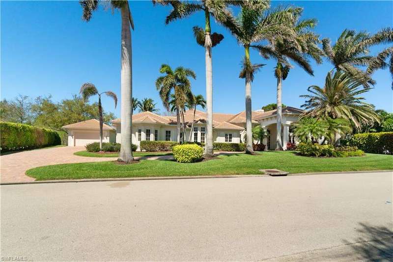 Fabulous curb appeal showcasing beautiful Tall Palm Trees along the circular driveway with an extremely rare 5 car garage.