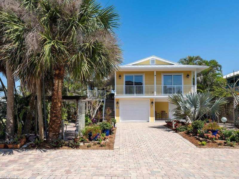 Coastal inspired home with driveway and an attached garage