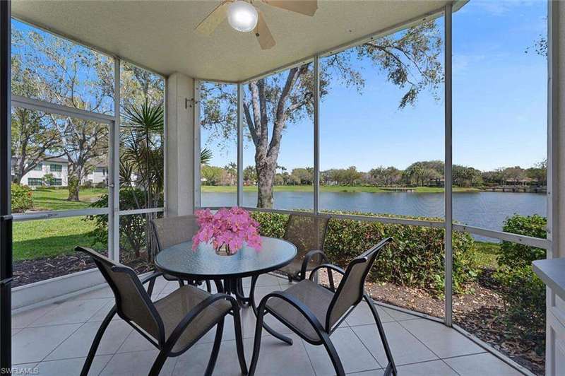 Sunroom / solarium with a ceiling fan, a water view, healthy amount of natural light, and outdoor dining space