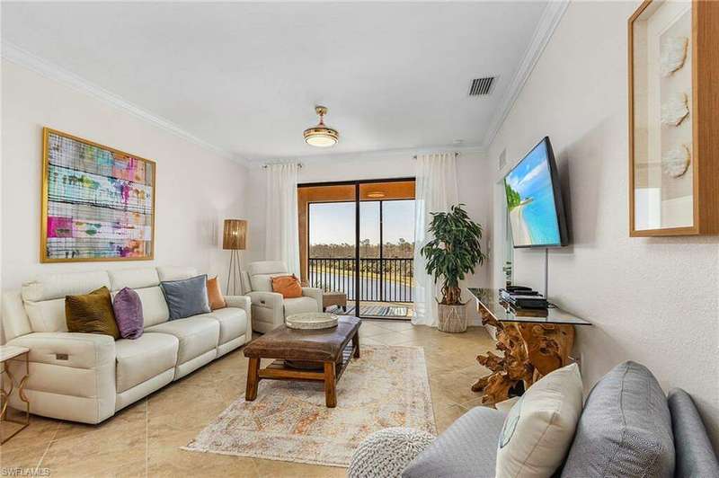 Tiled living room featuring ornamental molding