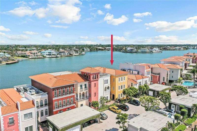 Virtually staged Great Room with hardwood floors and eastern view of Venetian Bay.