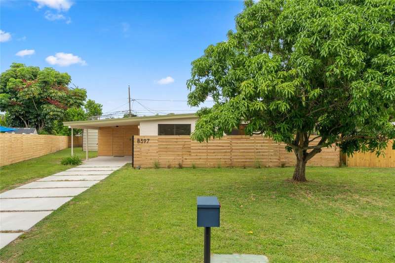 Completely renovated with new modern concrete pavers and fruit-producing Mango tree.