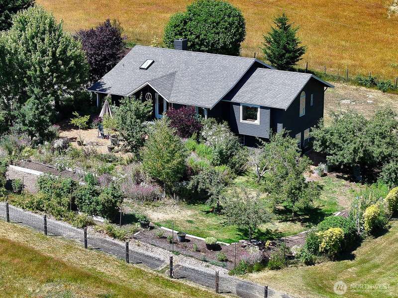 Fruit trees, berries, flowers and mature landscape create a private front yard. The yard is surrounded by pasture land providing a gorgeous territorial view and lots of light.