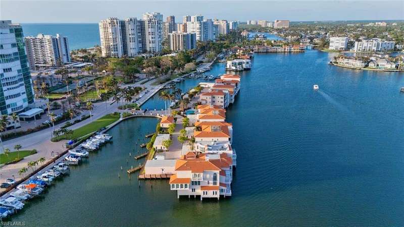 View of urban area with a large body of water and a marina
