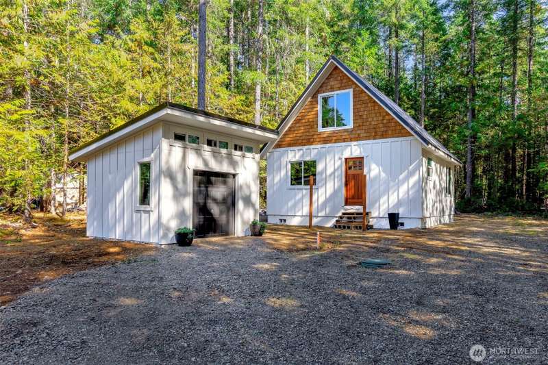 All the hard work is done...This beauty is ready for the final finishes! Beautiful lot with circular drive, sunny interior and tree's left around the perimeter for privacy. Home is framed with windows, doors, and roof.  24' x 24' footprint with 576 SQ FT 