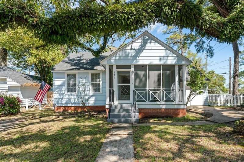 View of front of house featuring a front yard, a sunroom, and fence