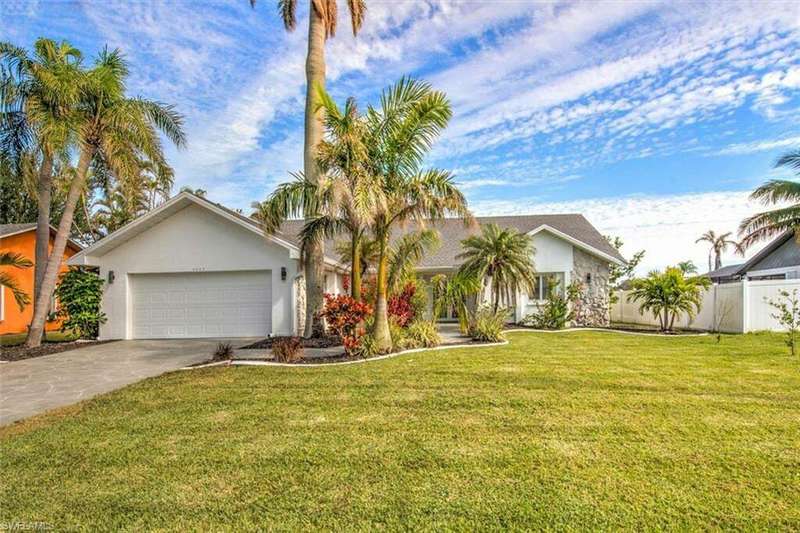 View of front of home featuring a garage and a front lawn