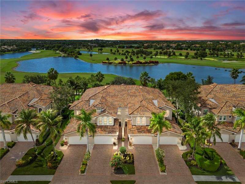 View of subject property with a golf club and a large body of water