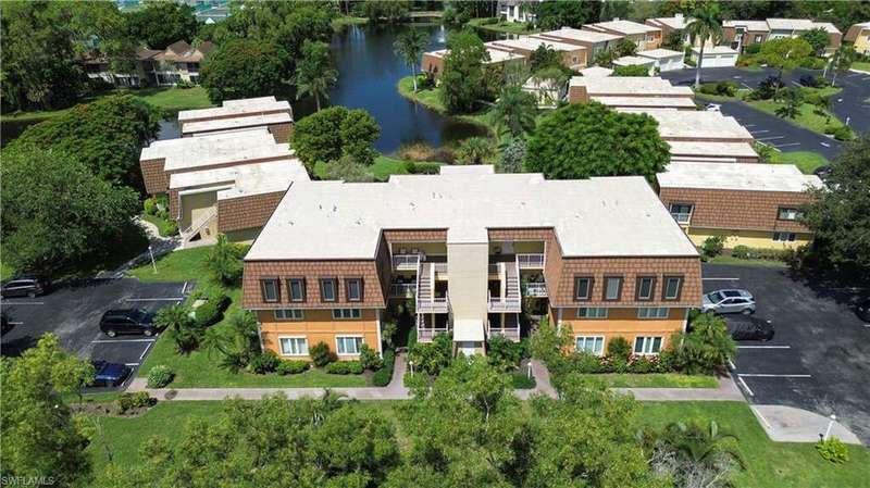 Aerial perspective of suburban area featuring a large body of water