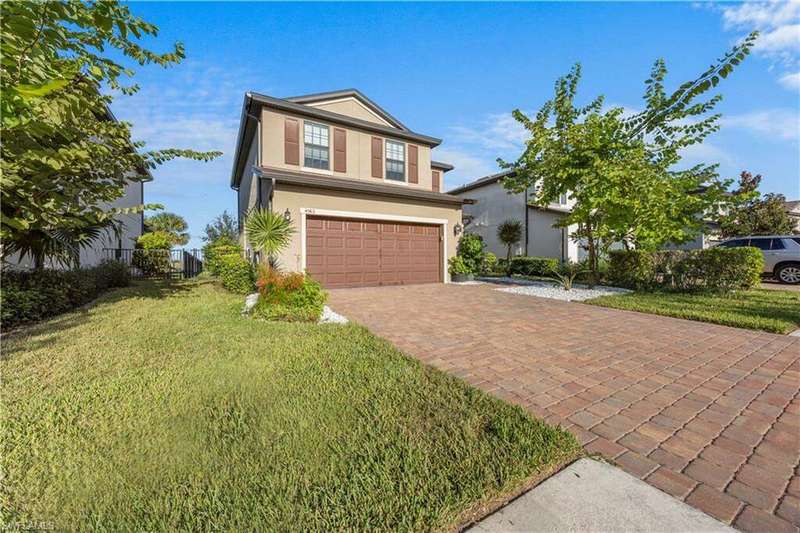 View of front of house with stucco siding, an attached garage, and decorative driveway