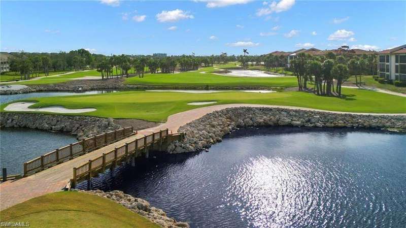 Surrounding community featuring a water view, view of golf course, and a lawn