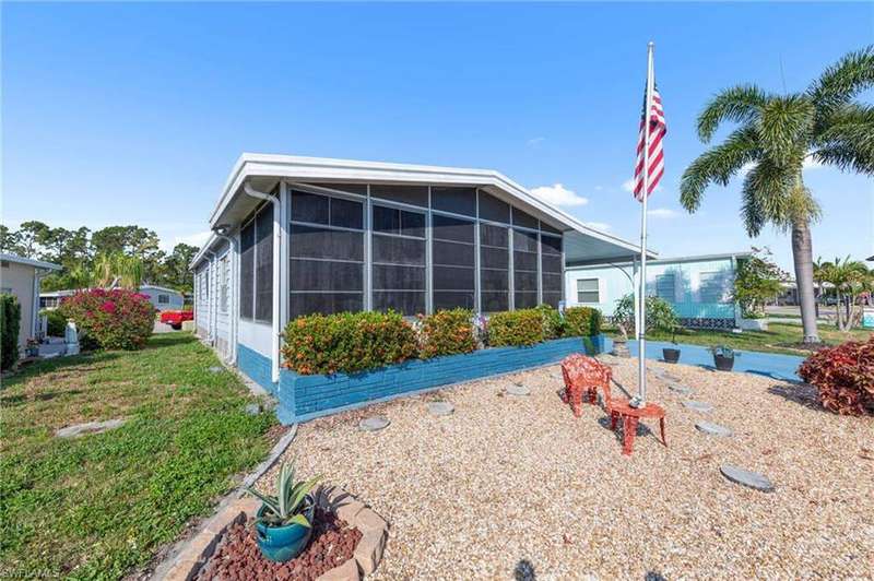 Rear view of property featuring a sunroom