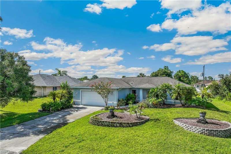 Detached single story home with a garage and a front yard