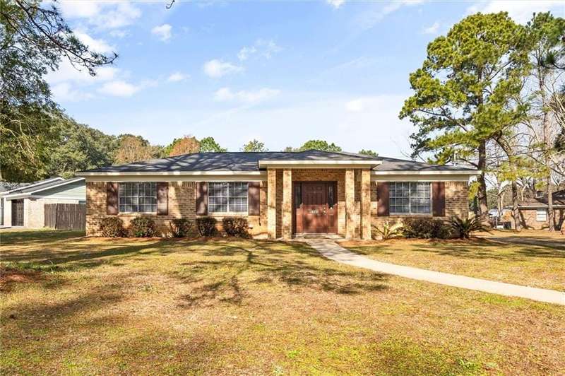 Ranch-style home with a front yard