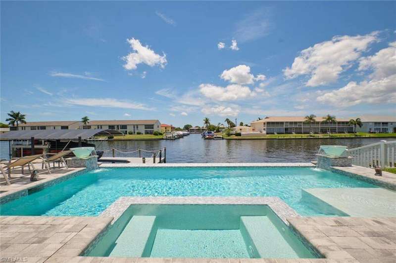 View of swimming pool with pool water feature, an in ground hot tub, and a patio area