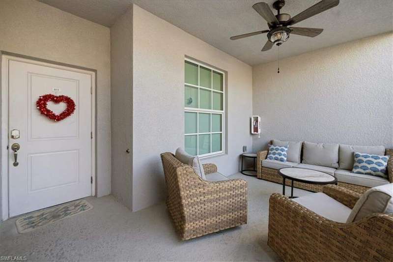 Property entrance with an outdoor hangout area and ceiling fan