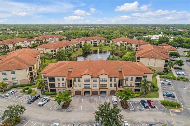 Drone / aerial view of a large body of water and apartment complex