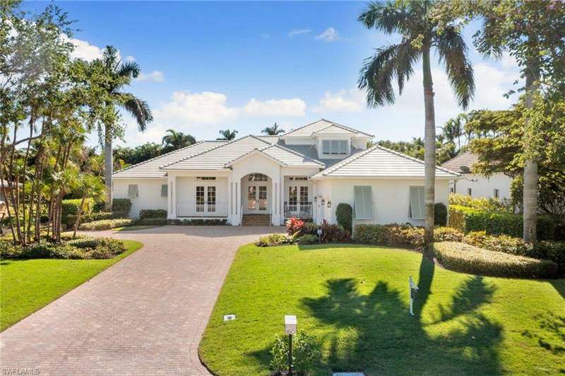 View of front of house featuring a front yard and french doors