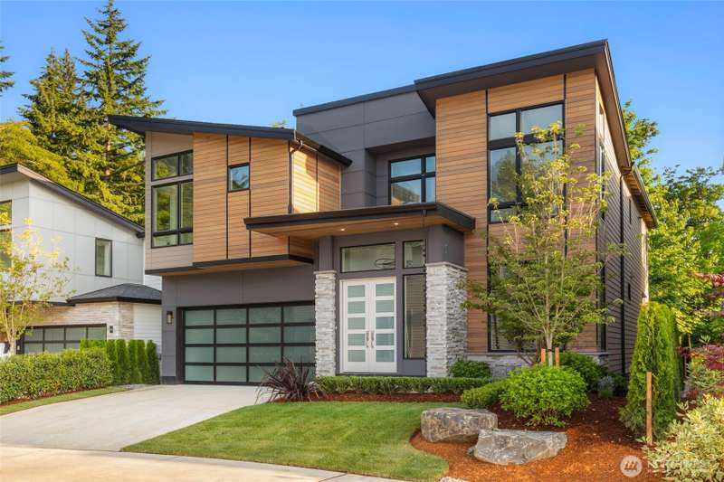 French door entry with covered porch featuring stained cedar soffits