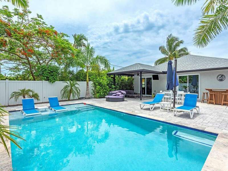 View of swimming pool with a patio area and a jacuzzi