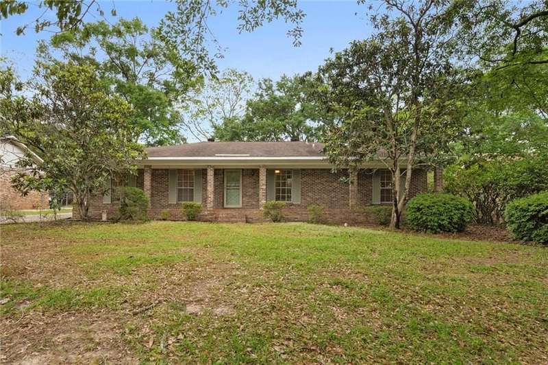 Ranch-style house featuring a front lawn and brick siding