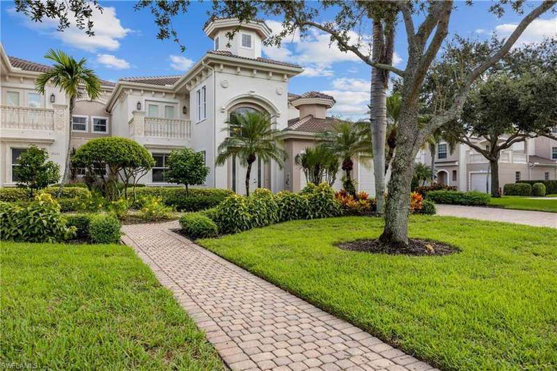 Stylish Mediterranean penthouse condo with new roof, modern exterior lighting, freshly painted, two-car garage, and prime corner location lives like a family home