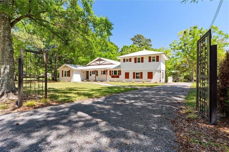 Colonial-style house with a front yard and driveway