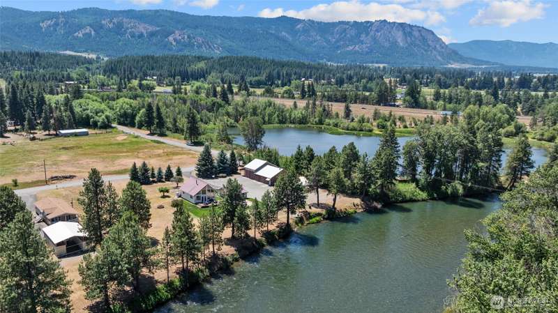 This exceptional property includes two homes, two shops, and a charming cabana, making it ideal for multigenerational living, vacation rental potential, or a private getaway with room for guests and gear.