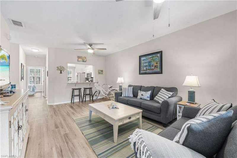 Living room with ceiling fan and luxury vinyl tile flooring and BRAND NEW COUCHES