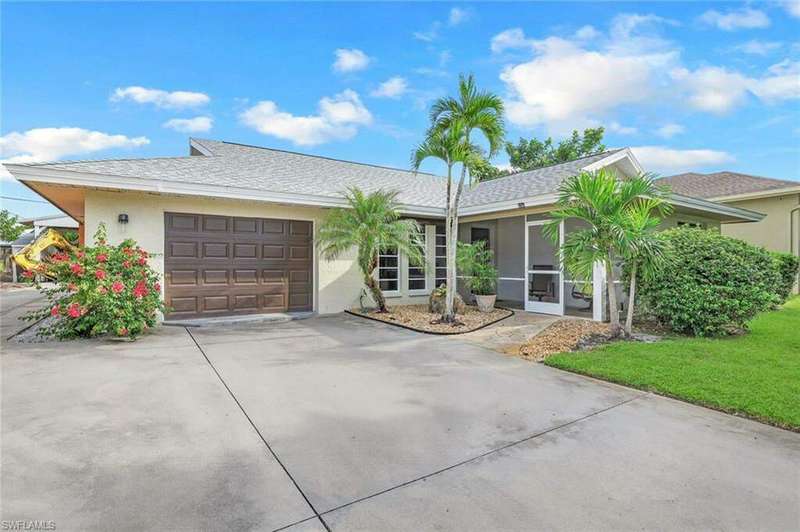 Ranch-style home with a garage and a front yard